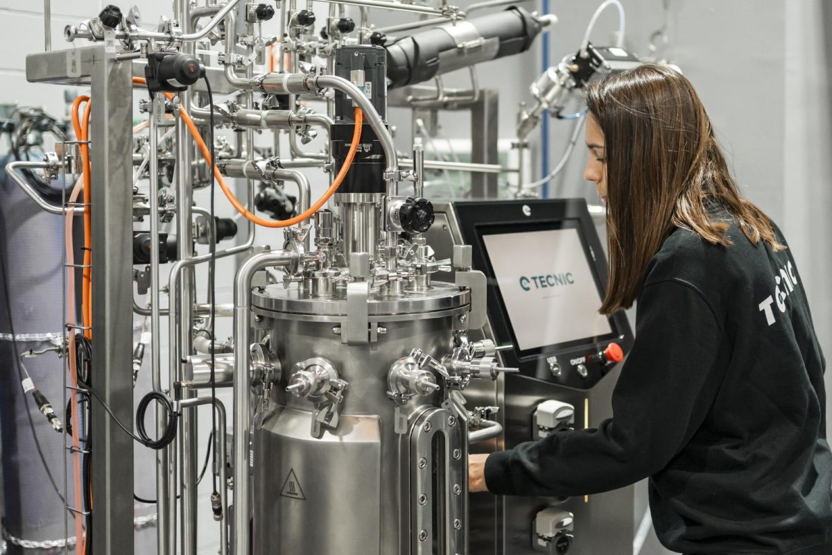 A woman from behind working on **biotechnology professions** related to bioprocess equipment, specifically bioreactors.